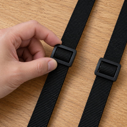Hand sliding the length slider along one lead of the double dog leash