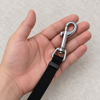 Open palm holding a metal snap hook on its swivel fitting