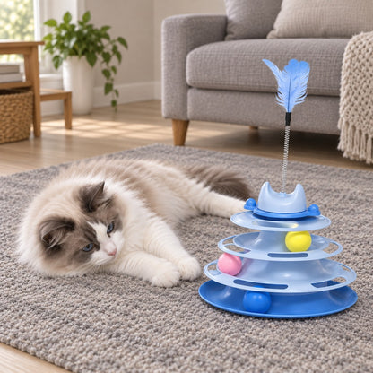 Cat resting on the floor beside the ball track tower