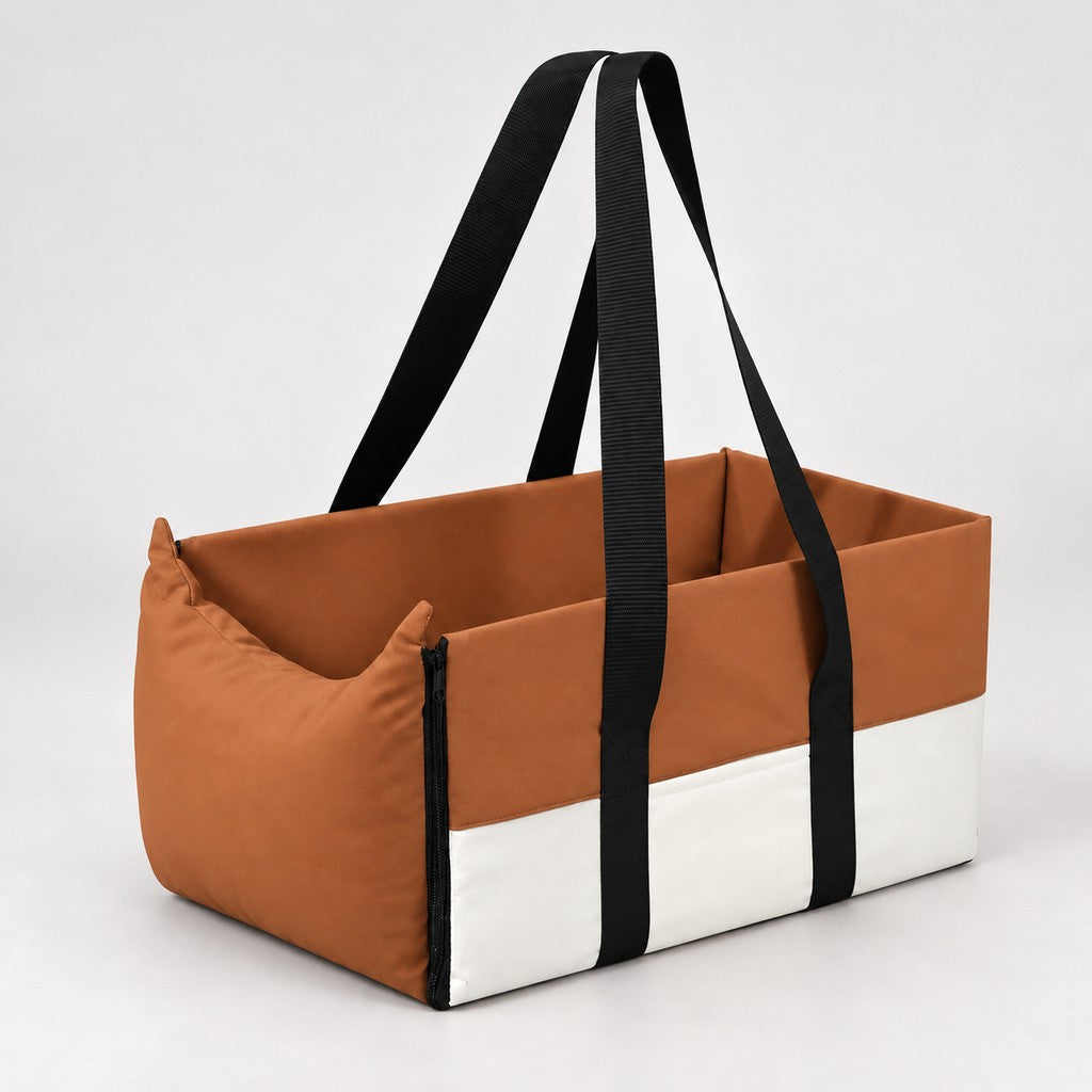 Brown and cream open-topped pet car bed with two black handles on a light background