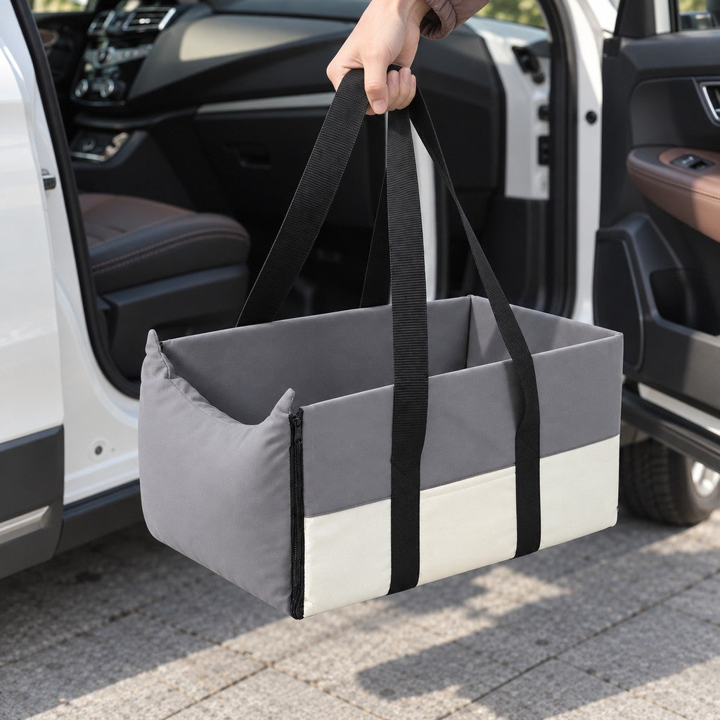 Person carrying the empty grey pet bed by its two long black handles