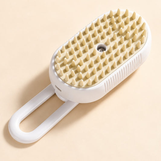 White oval grooming brush with cream cone-shaped teeth, round central hole and looped handle on peach
