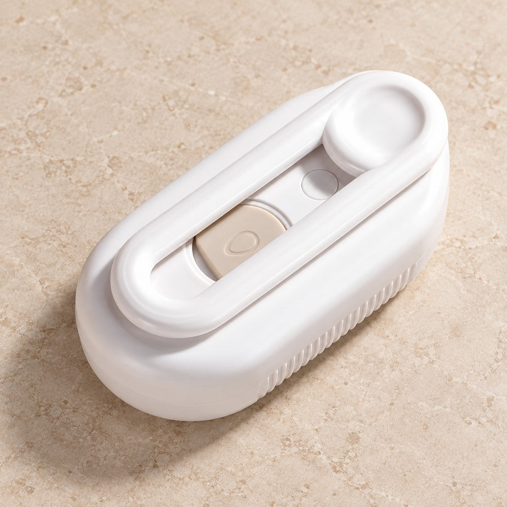 Back of the white brush with its looped handle folded flat, resting on a marble-look surface