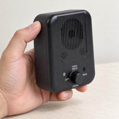 Hand lifting the compact black training device, showing it fits in one hand
