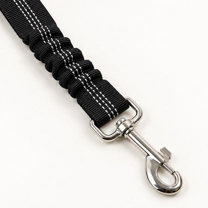 Close view of the swivel clip and ruched elastic section of the black reflective-stitched strap