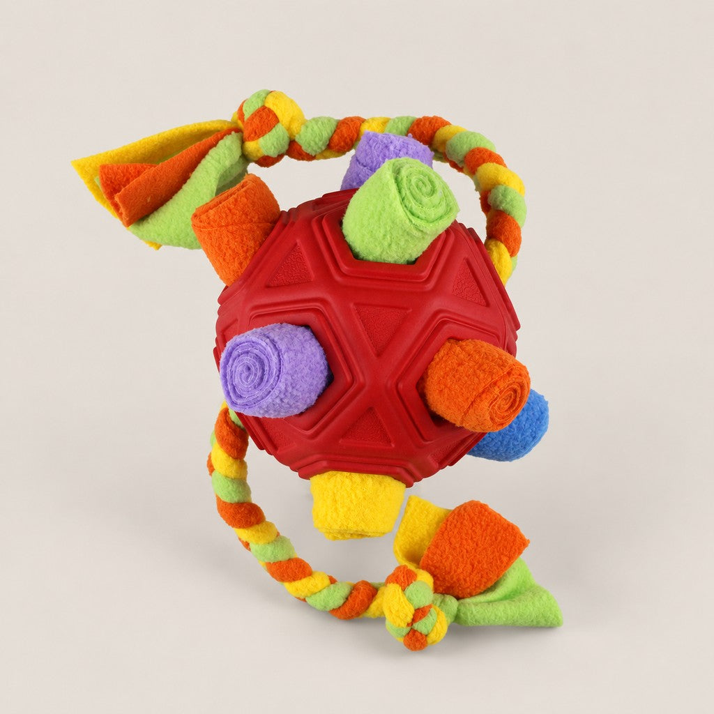 Red faceted snuffle ball with fleece rolls and multi-coloured braided rope on white