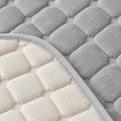 Reverse side of the throw showing cream underside with dotted surface