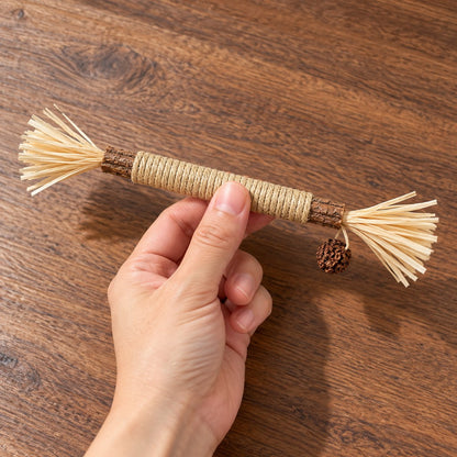 Hand gripping the middle of the stick, showing its length and tufts