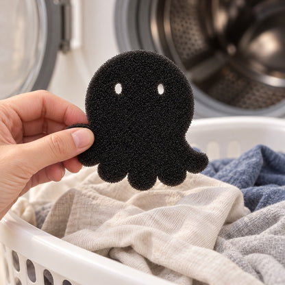 Hand lifting the foam octopus out of a basket of laundry