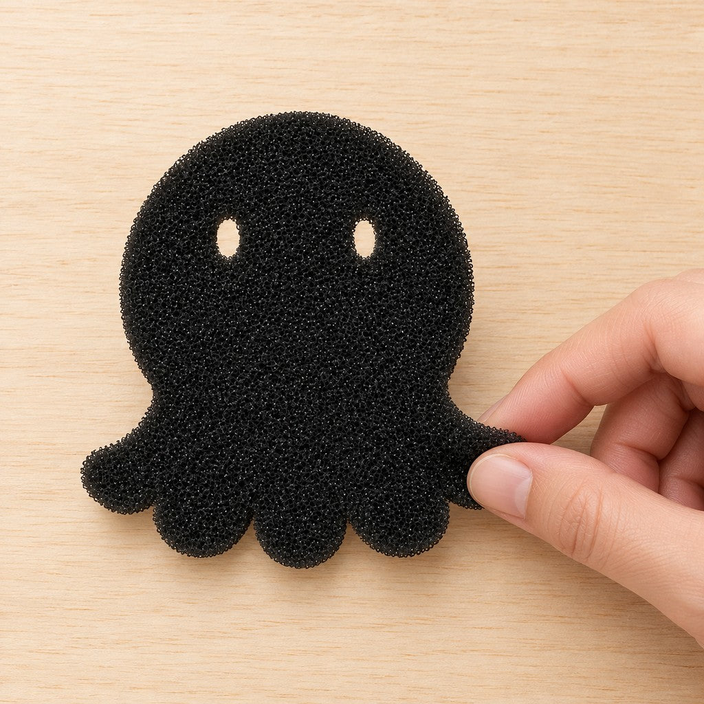 Hand picking up the black foam octopus by its tentacle