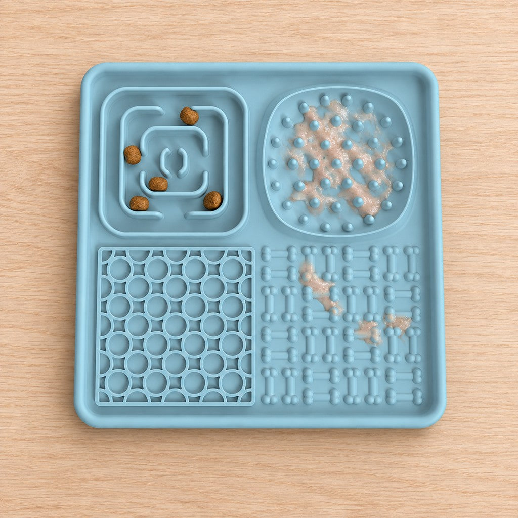 Blue lick mat with kibble in the maze zone and paste on the studs and bones