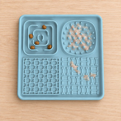 Blue lick mat with kibble in the maze zone and paste on the studs and bones