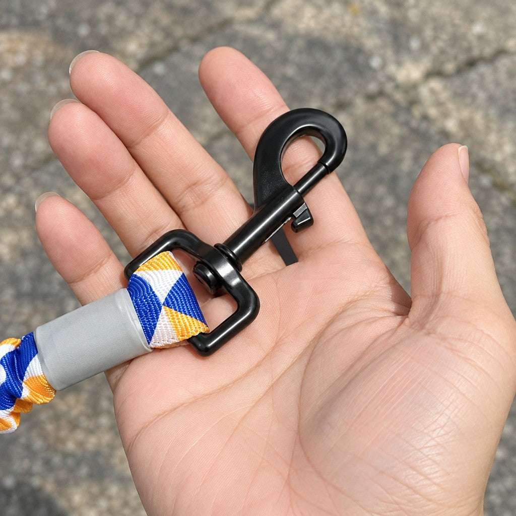 Hand holding the black snap hook to show its size against the palm