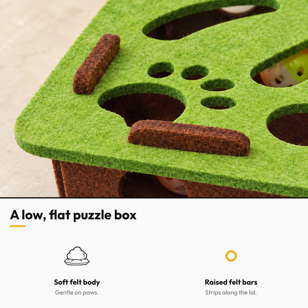 Hide & Seek – A low, flat puzzle box: soft felt body, raised felt bars