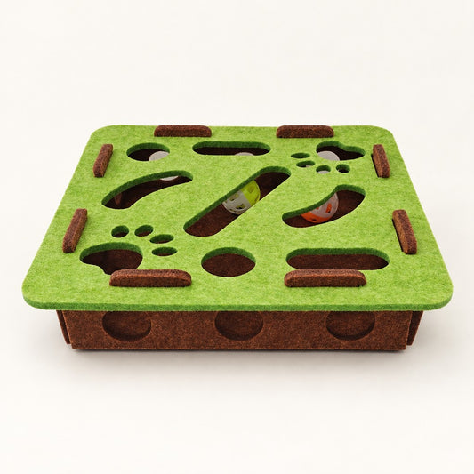 Square green-brown felt puzzle box with paw-shaped openings and balls visible inside