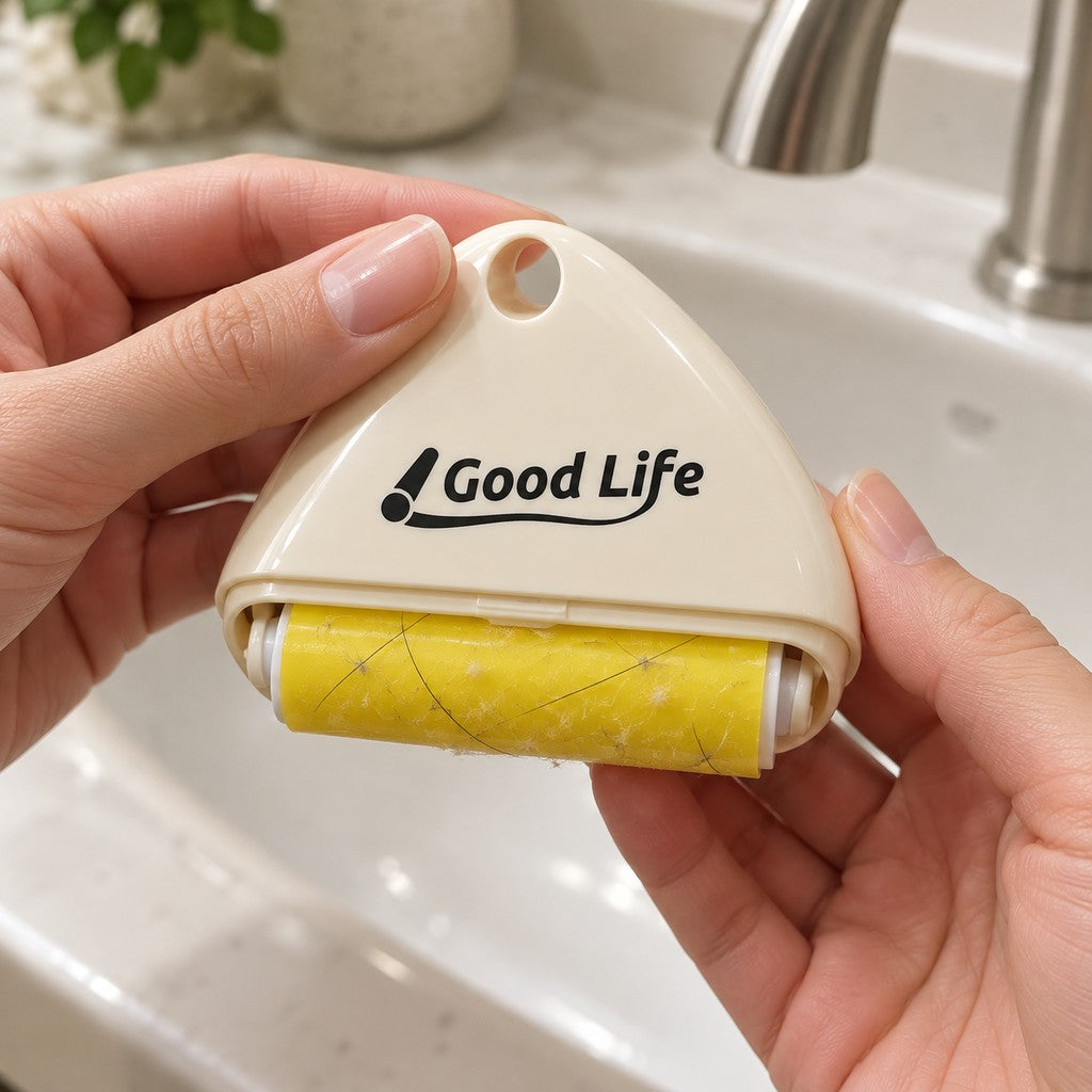 Hands holding the cream roller over a basin, yellow sticky roll visible