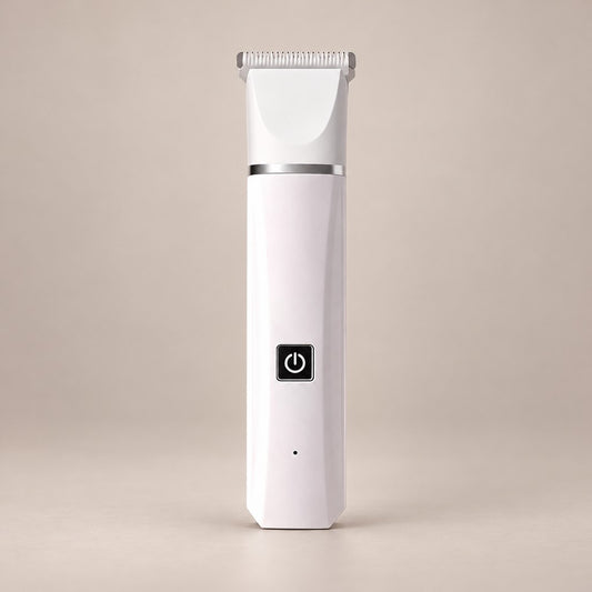 Slim white pet hair trimmer with wide comb head, silver band and black button