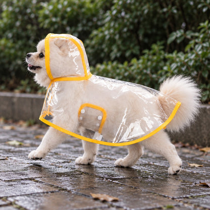 Small cream dog in the clear hooded cape mid-step on a wet paved path
