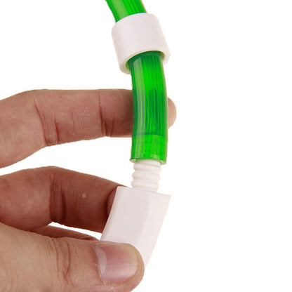 Fingers holding the green tube end and the white control unit apart at the ribbed connector