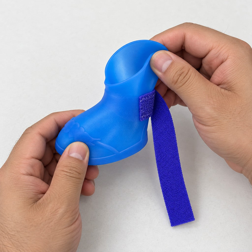 Hands holding a blue bootie with the strap pulled out at the cuff