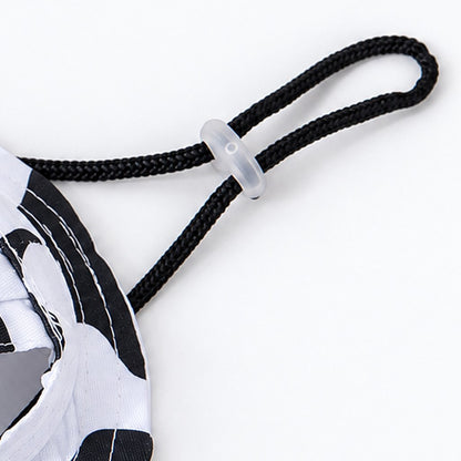 Close-up of black braided cord with clear toggle beside the cow-print hat brim
