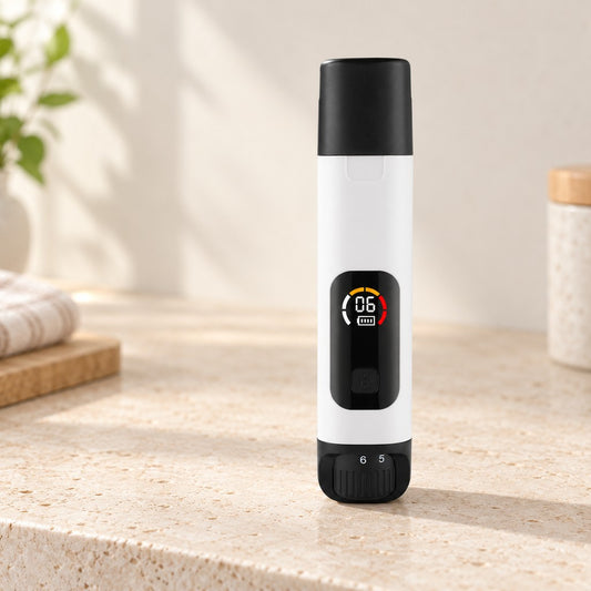 White pen-style nail grinder with black cap and colour display standing on a stone counter