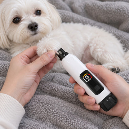 Hands smoothing a nail on a small white dog's paw with the grinder