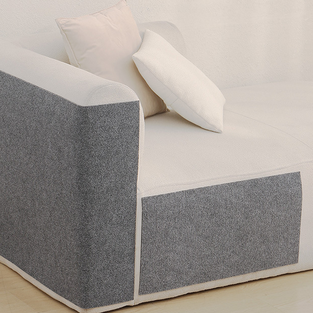 Stick-On Sofa Scratch Panel — Dark Grey panels on a cream sofa