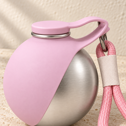 2-in-1 Travel Water Bottle — close-up of the pink silicone cap and carry strap on the steel bottle